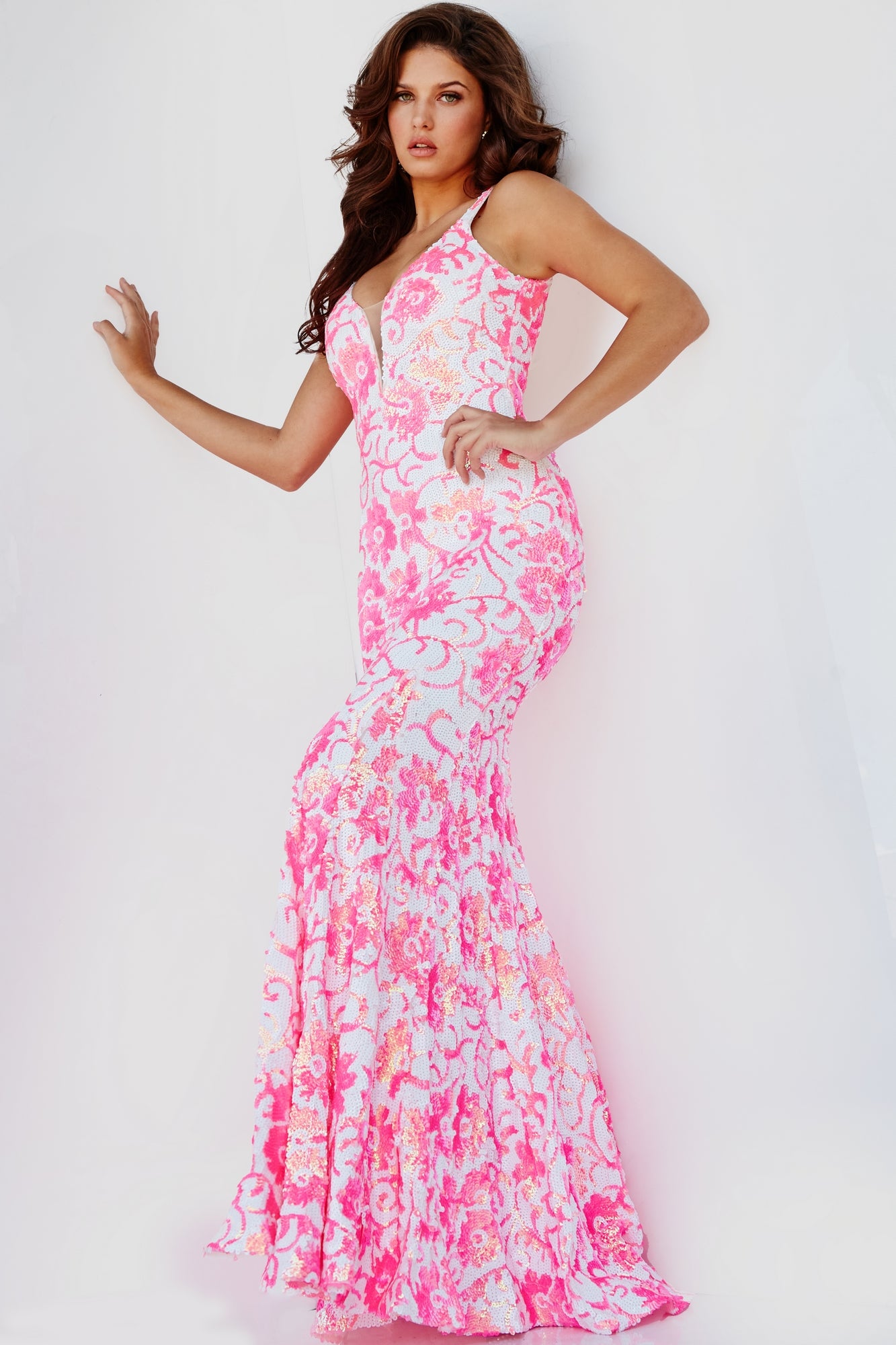 A woman poses against a white background, wearing the Jovani 08257 Sequin Prom Dress with Floral Print—a sleeveless, floor-length pink and white gown featuring a fitted bodice and flared skirt.